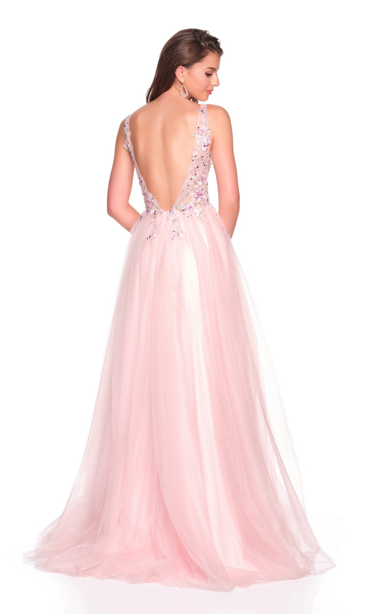 A woman models the Dave and Johnny 12591 long prom dress, featuring a floral-embroidered bodice, flowing light pink tulle skirt, and low open back, highlighting the gown's elegant A-line silhouette.